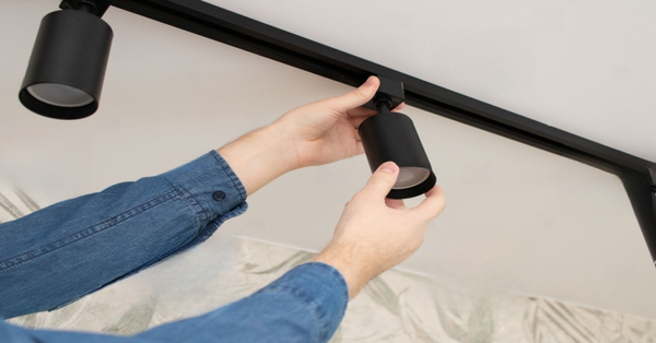 PS stock photo a man install a spot track led light in the ceiling 2274059721 transformed 600x600