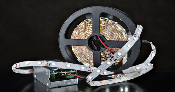 stock photo close up luminous led light strip on the reel near the voltage transformer converter on black 515372377 transformed 600x600